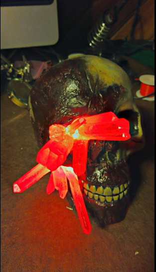 Illustration for article titled Glowing Red lyrium Skull (TW: Gore)